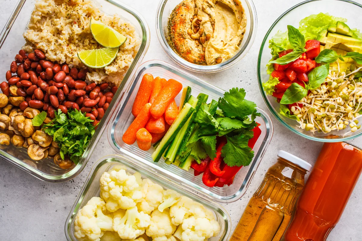 Lunch containers with vegetables, beans and hummus