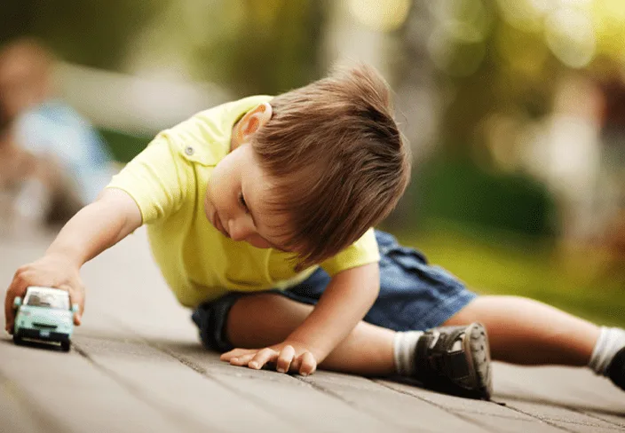 boy holding a toy car
