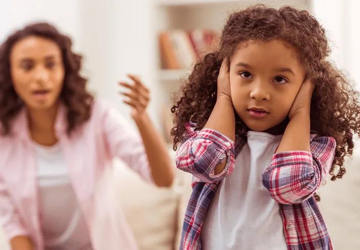 girl holding her ears